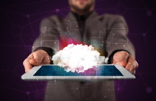 Businessman holding tablet with cloud icon and purple background