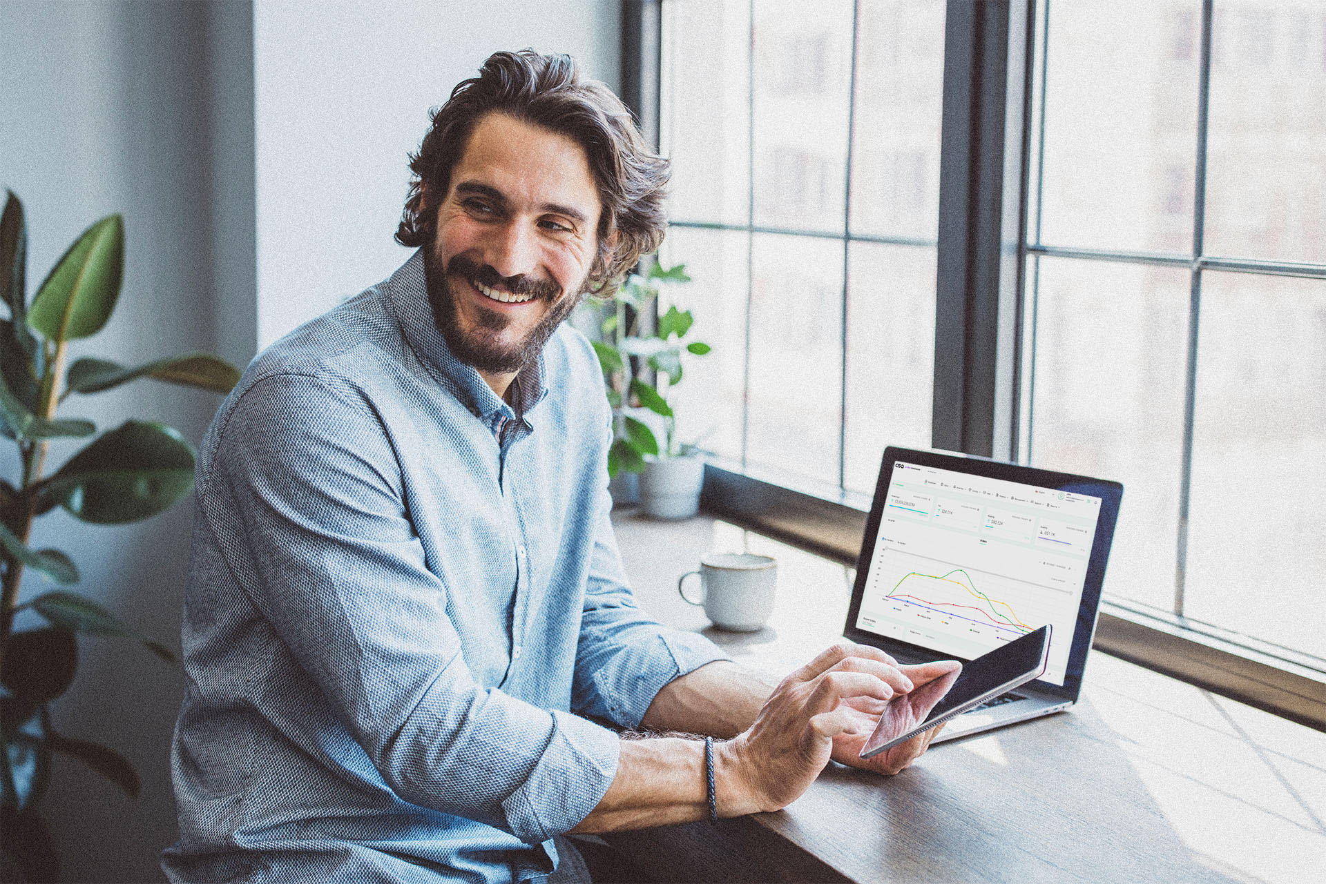 white man with phone and laptop-min